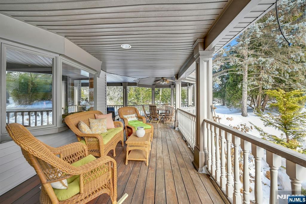 285 Chestnut Ridge Road Woodcliff Lake, NJ 07677 - Photo 4 of 46 a view of a patio with table and chairs and wooden floor