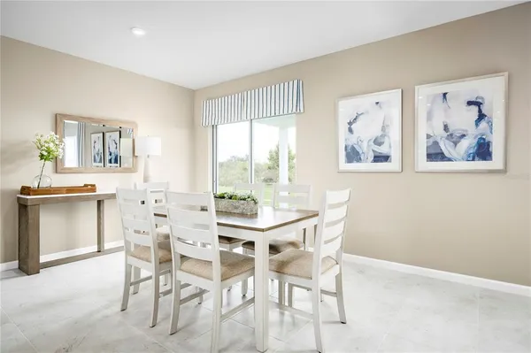 a view of a dining room with furniture and a large window