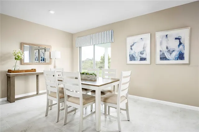 a view of a dining room with furniture and a large window