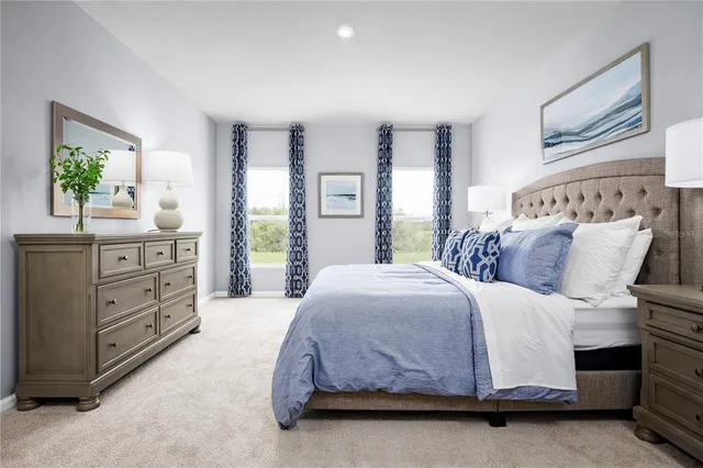 a spacious bedroom with a bed and a dresser