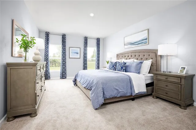 a spacious bedroom with a bed and window