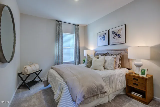 a living room with furniture a flat screen tv and a large window
