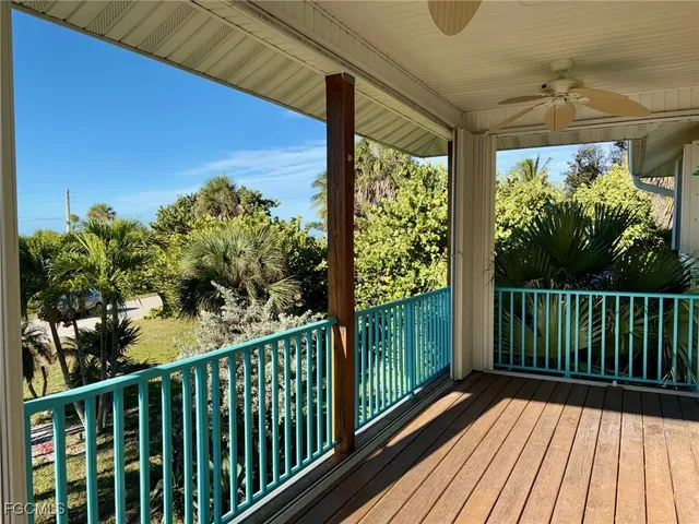 a view of a room with wooden floor and windows