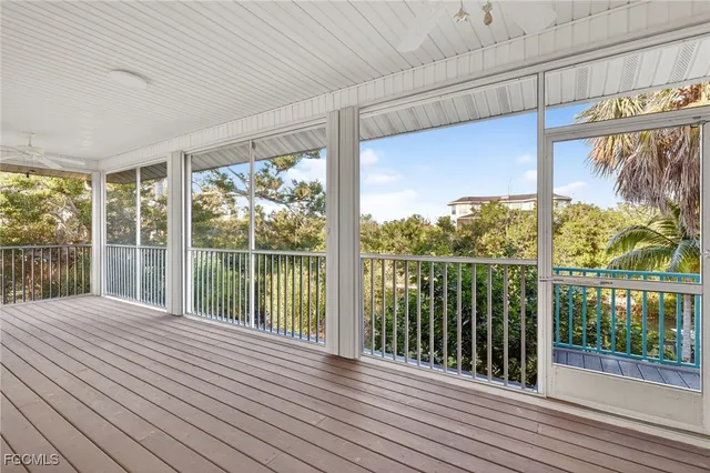 an empty room with windows and outdoor view