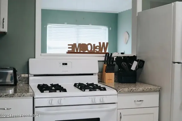 a kitchen with a stove and a refrigerator