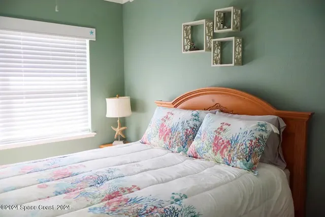 a bedroom with a bed and a window