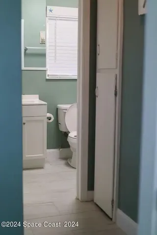a bathroom with a toilet and a vanity