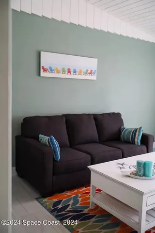 a white couch sitting next to a white wall