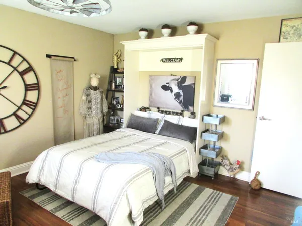 a bedroom with a bed and a mirror
