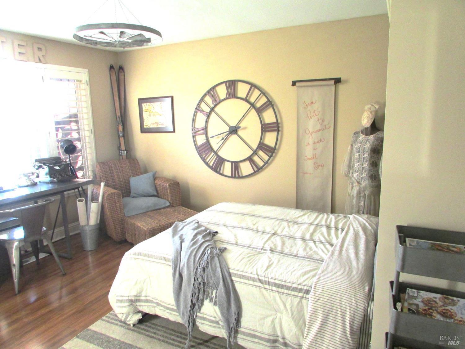 7409 Oakmont Drive Santa Rosa, CA 95409 - Photo 25 of 44 a bedroom with a bed a mirror and a large window