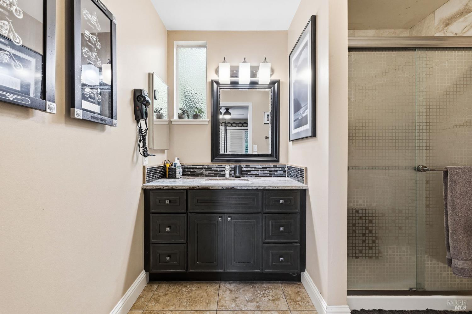 7409 Oakmont Drive Santa Rosa, CA 95409 - Photo 28 of 44 a bathroom with a sink a mirror and a shower