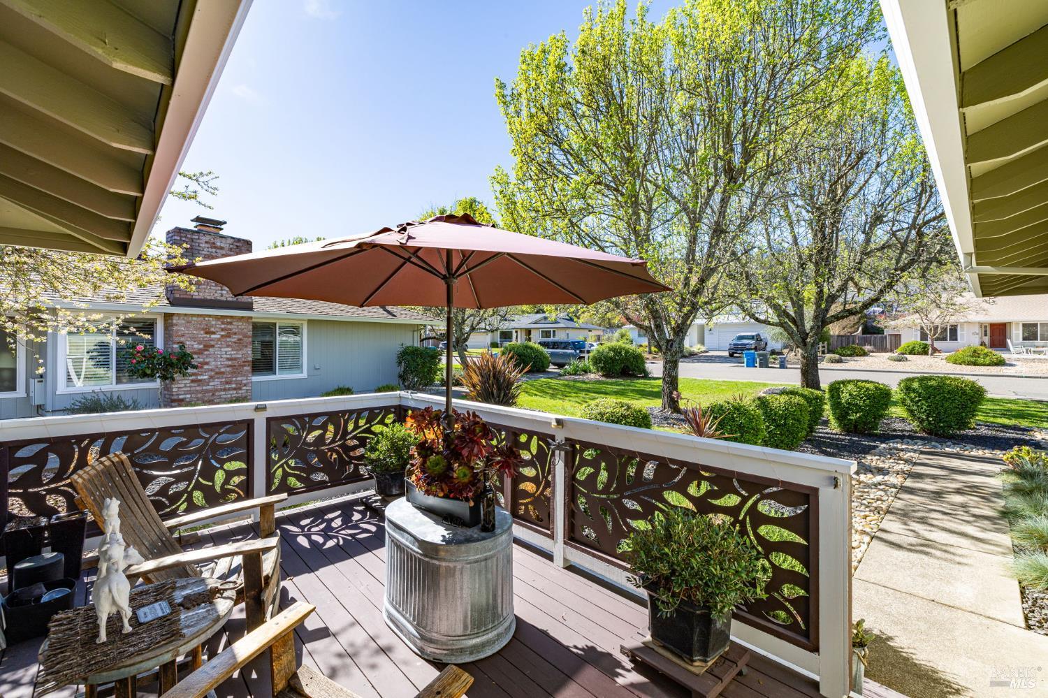 7409 Oakmont Drive Santa Rosa, CA 95409 - Photo 5 of 44 a view of a chair and tables under an umbrella