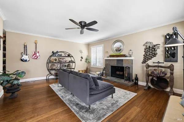 a living room with furniture a clock and a fireplace