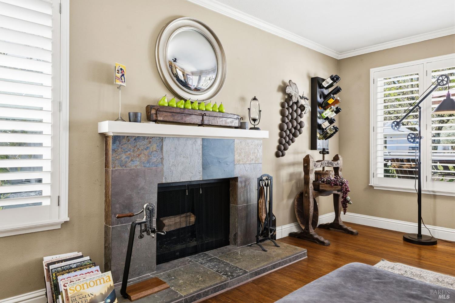 7409 Oakmont Drive Santa Rosa, CA 95409 - Photo 10 of 44 a living room with furniture a mirror and a fireplace