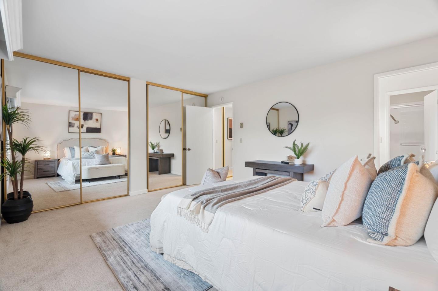 100 East Middlefield Road, Unit 6G Mountain View, CA 94043 - Photo 13 of 34 a bedroom with a bed and a large mirror