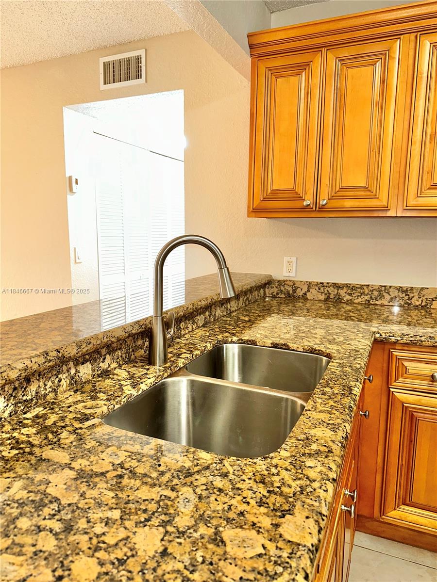 1620 Balfour Point Drive, Unit G West Palm Beach, FL 33411 - Photo 5 of 15 a kitchen with a sink and a window