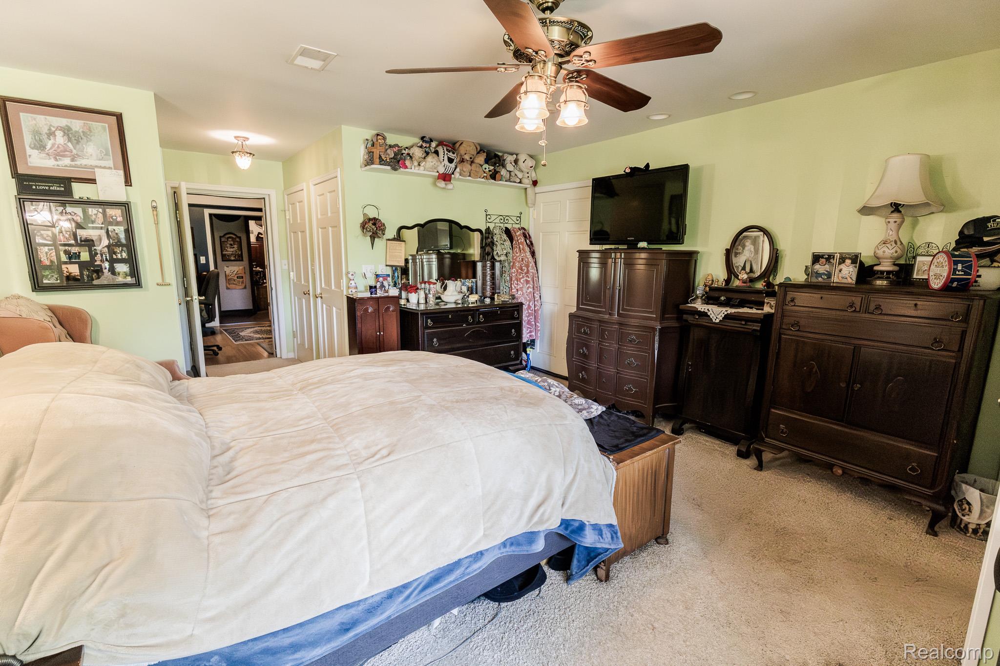 8197 Irish Road Millington, MI 48746 - Photo 35 of 38 Carpeted room featuring a ceiling fan with integrated lighting, light green walls, a white ceiling, and white interior doors