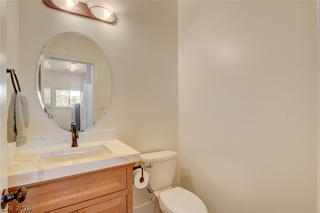 4362 Thistle Street Logandale, NV 89021 - Photo 65 of 99 A well-appointed half-bath offers a sleek vanity with a basin sink and a contemporary mirror.