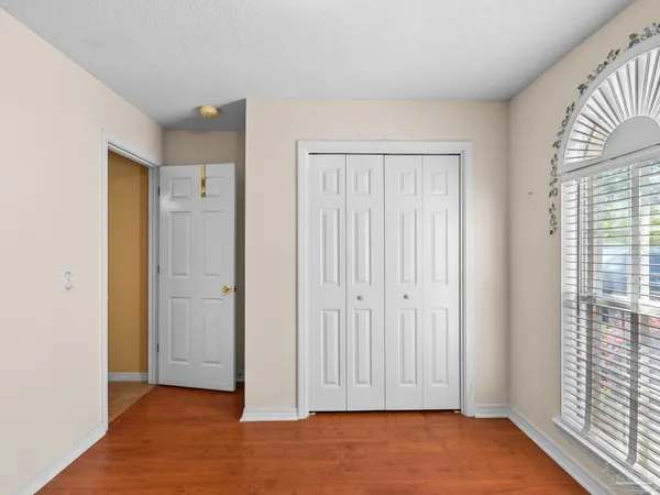 an empty room with windows and closet