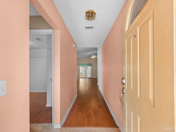 a view of a hallway with wooden floor
