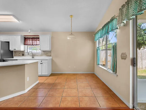 a kitchen with a sink a counter top space and cabinets