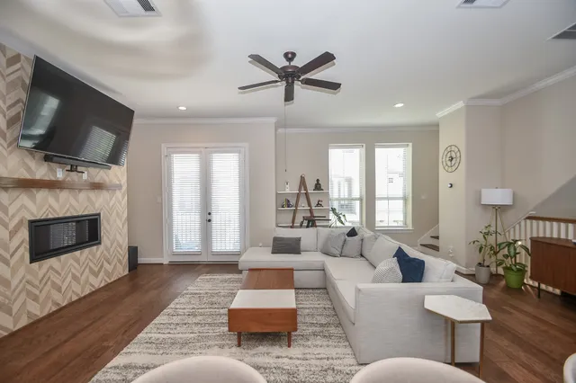 a living room with furniture a flat screen tv and a fireplace