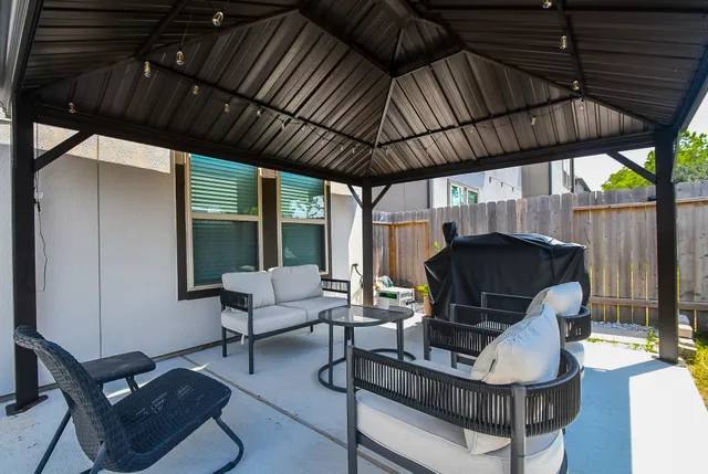 a patio with a patio table and chairs