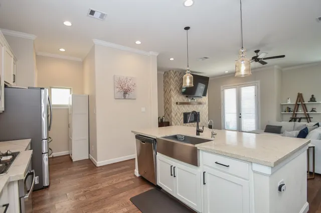 a kitchen with stainless steel appliances white cabinets and a granite counter tops
