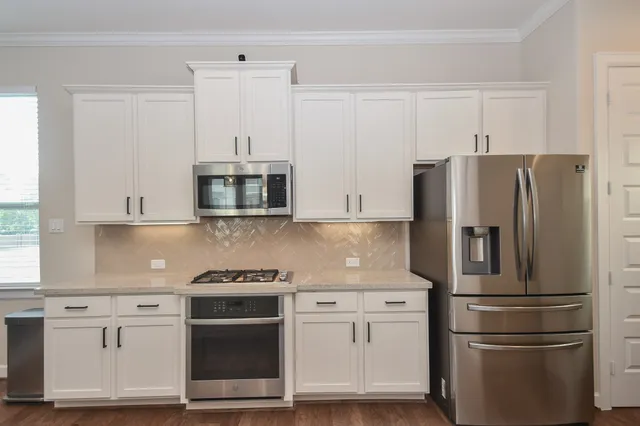 a large kitchen with a table and chairs