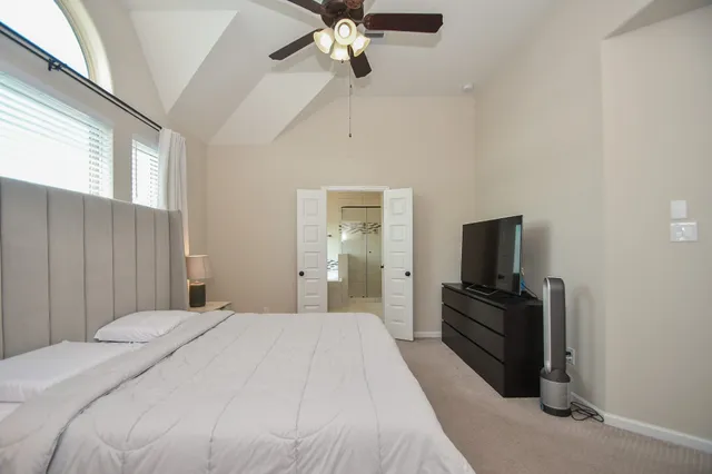 a bedroom with a bed and a television