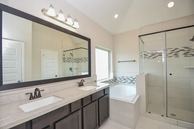 a bathroom with a shower sink and mirror