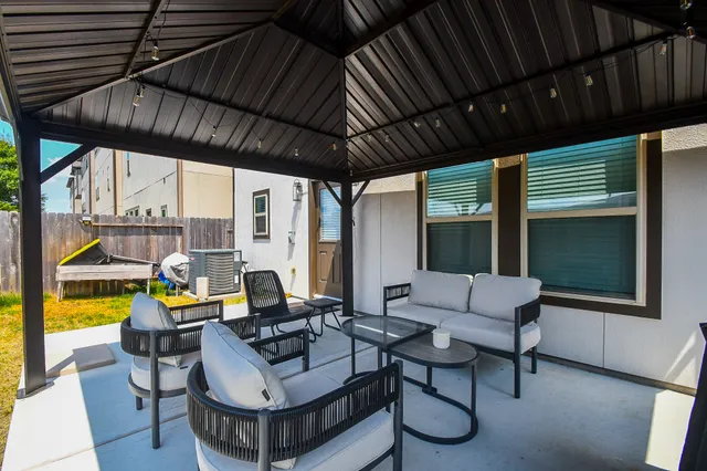 a view of swimming pool with table and chairs under an umbrella