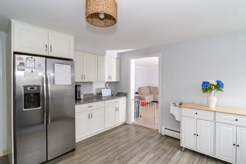 a kitchen with a refrigerator and a sink