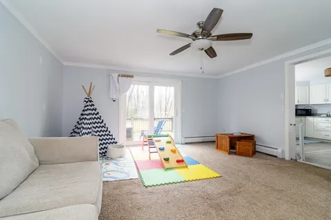 a living room with furniture and a chandelier