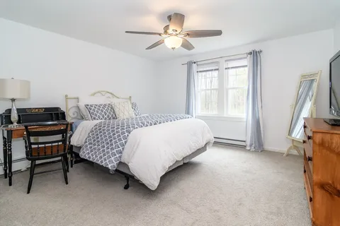 a bedroom with a bed and a chandelier