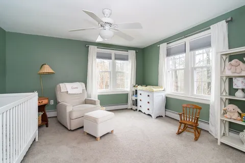 a bedroom with furniture and a large window