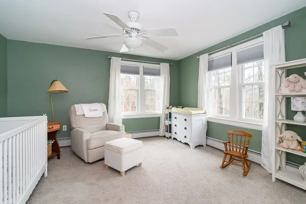 a bedroom with furniture and a large window