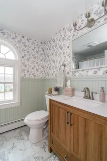 a bathroom with a sink a toilet and mirror