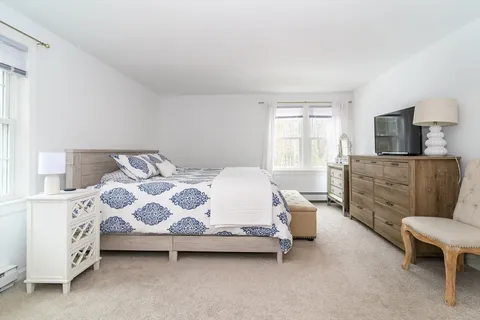 a bedroom with a bed and a furniture