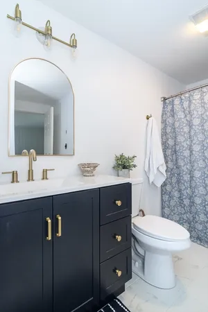 a bathroom with a toilet sink and mirror