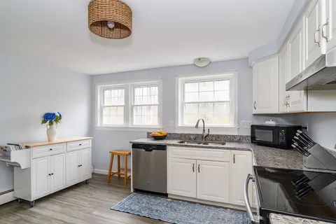a kitchen that has a sink and a stove in it