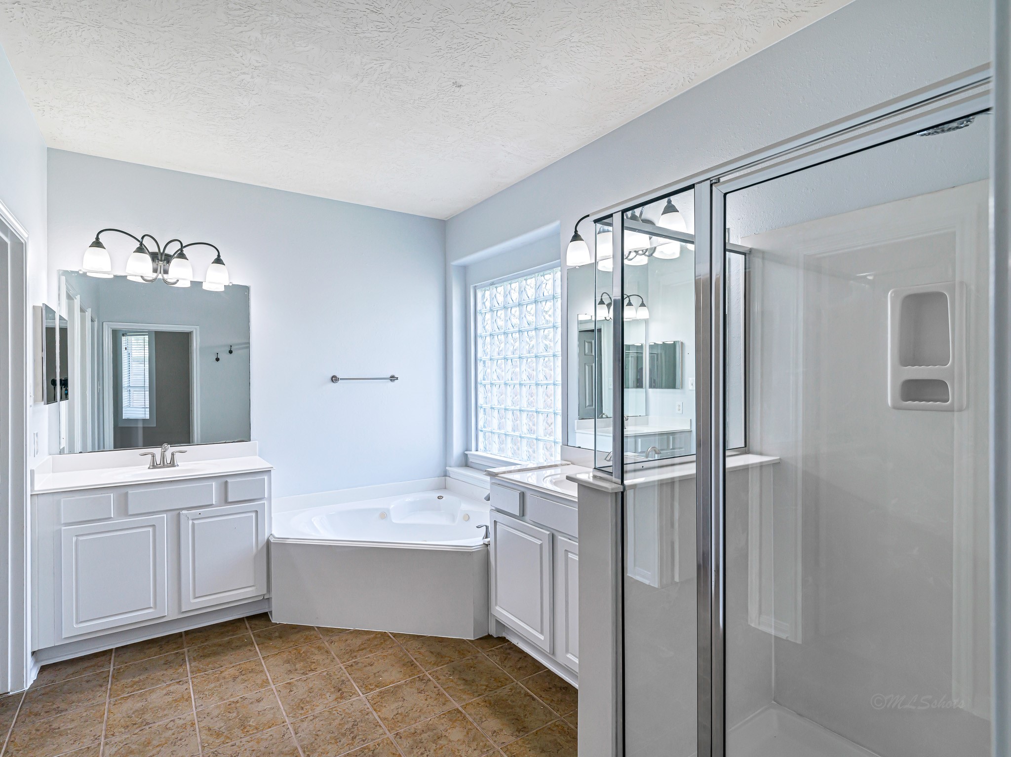 25203 Auburn Terrace Drive Spring, TX 77389 - Photo 14 of 21 a bathroom with a tub sink shower and mirror