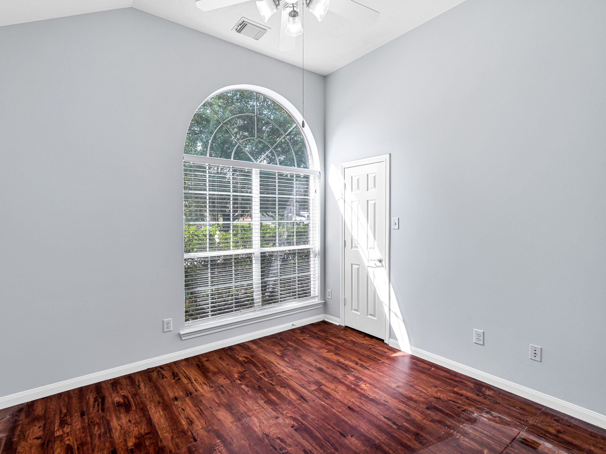25203 Auburn Terrace Drive Spring, TX 77389 - Photo 16 of 21 an empty room with wooden floor chandelier and windows