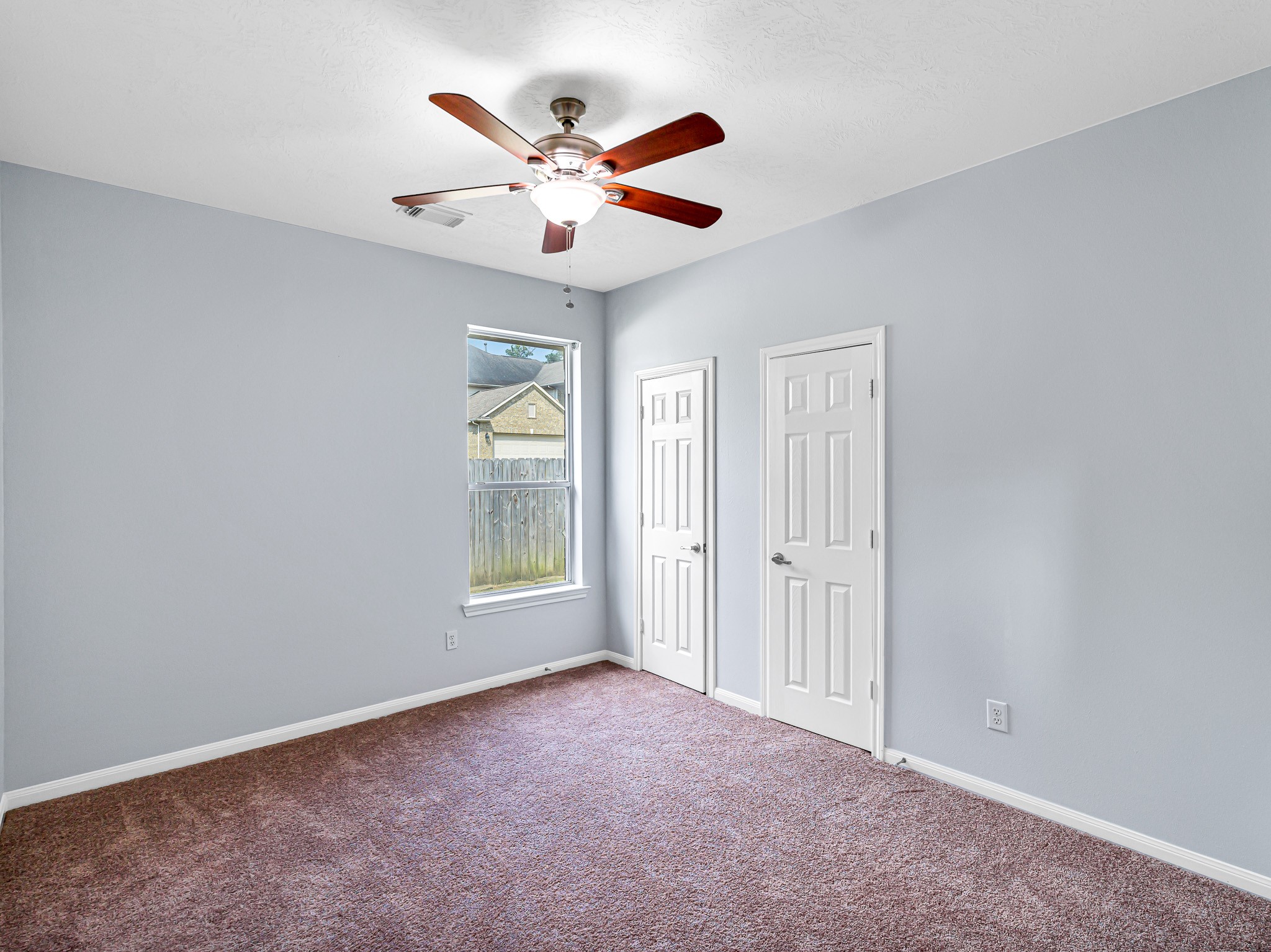 25203 Auburn Terrace Drive Spring, TX 77389 - Photo 18 of 21 an empty room with windows and fan