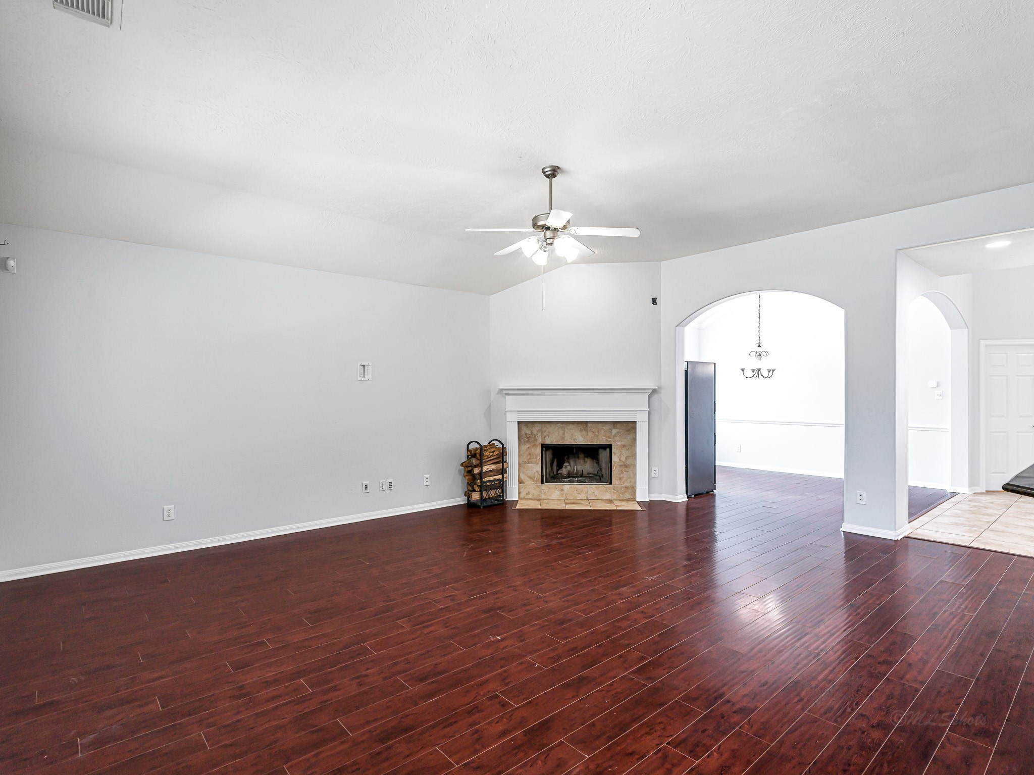 25203 Auburn Terrace Drive Spring, TX 77389 - Photo 10 of 21 an empty room with wooden floor fireplace and windows