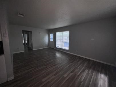 5011 Copperbend Boulevard, Unit B Austin, TX 78744 - Photo 2 of 10 a view of an empty room with wooden floor and a window