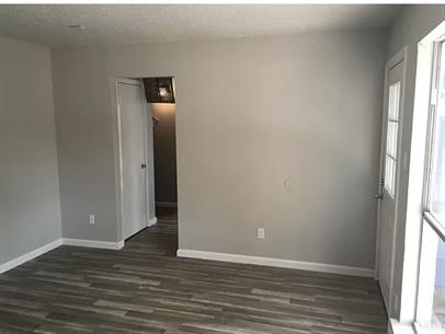 5011 Copperbend Boulevard, Unit B Austin, TX 78744 - Photo 3 of 10 a view of an empty room with wooden floor and a window