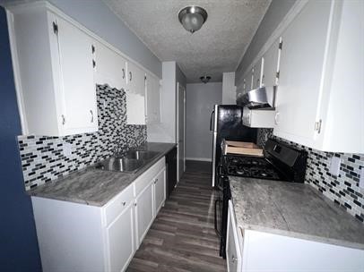 5011 Copperbend Boulevard, Unit B Austin, TX 78744 - Photo 5 of 10 a kitchen with granite countertop a sink and a stove