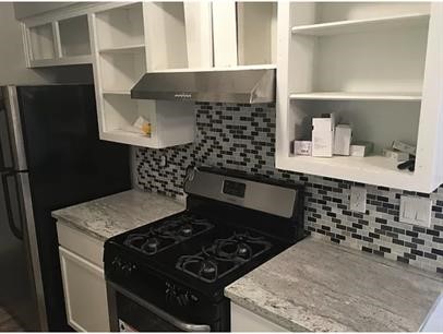 5011 Copperbend Boulevard, Unit B Austin, TX 78744 - Photo 6 of 10 a kitchen with granite countertop a stove and cabinets