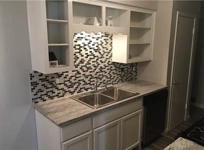 5011 Copperbend Boulevard, Unit B Austin, TX 78744 - Photo 7 of 10 a view of a sink and an empty room with wooden floor